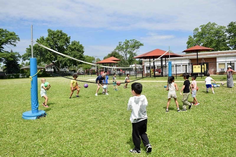 Students playing volleyball outside.