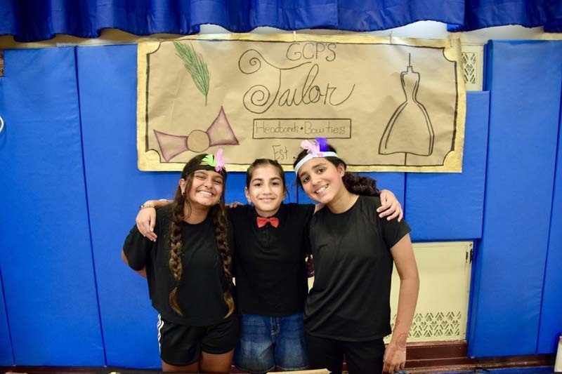 Students smiling together in gymnasium.