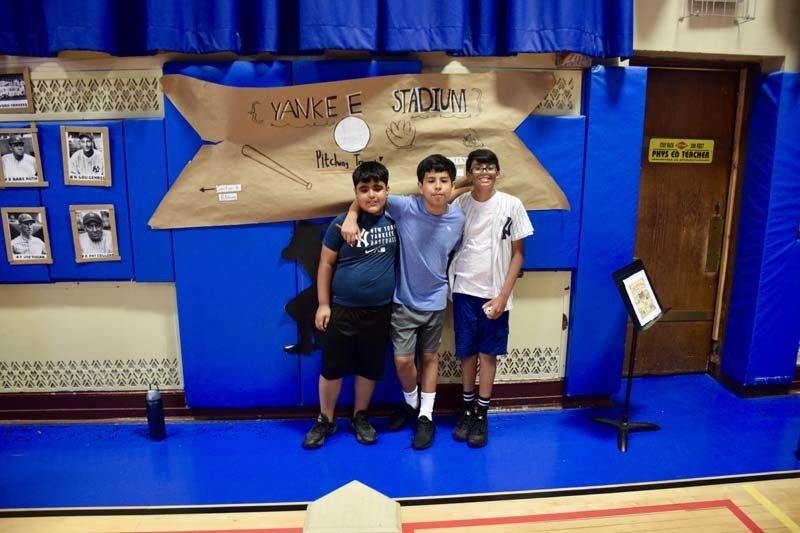 Students smiling together in gymnasium.