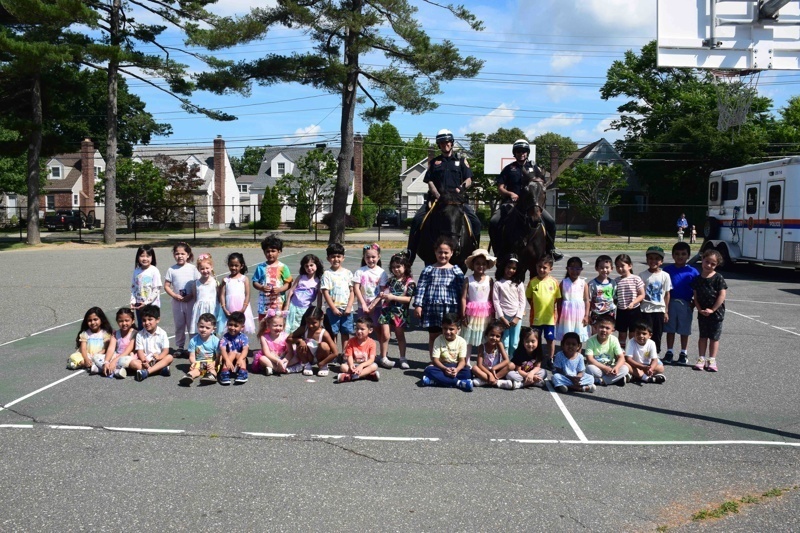 children gathered with police on horseback
