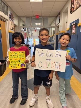 Students holding their artwork.