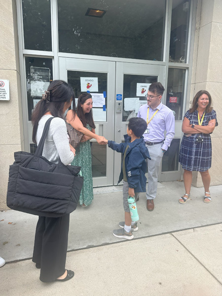 adult shakes hands with a young child