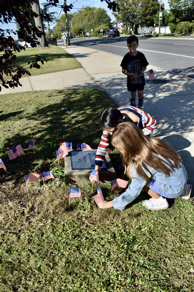 student looking at the memorial stone
