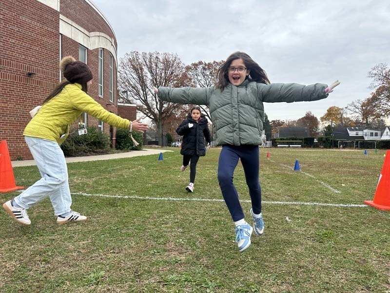 Students running outside.