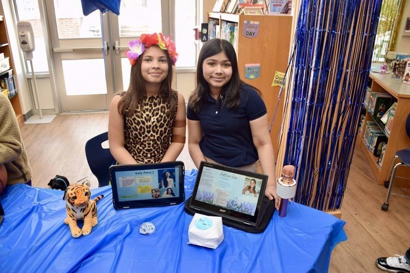 Students smiling with tablets.