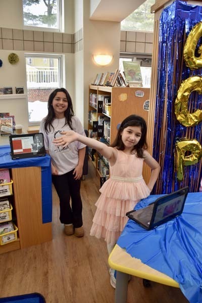 Students smiling with tablets.