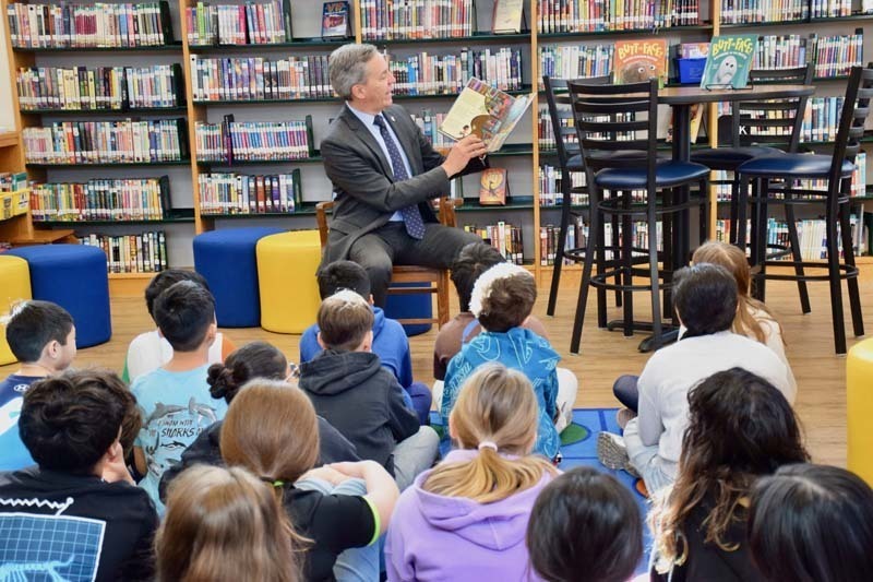 Man reading to students.