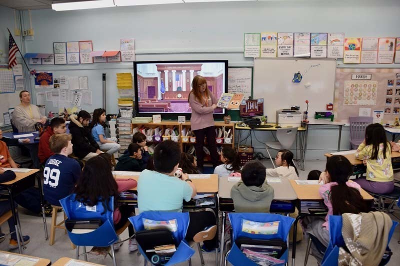 Teacher reading to students.