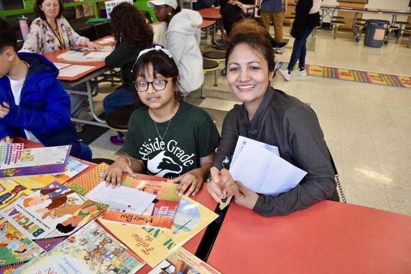 Parent and student smiling togther.