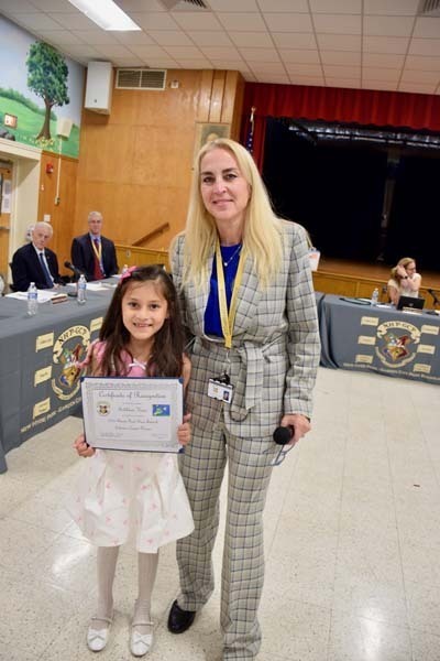 Student smiling with teacher .