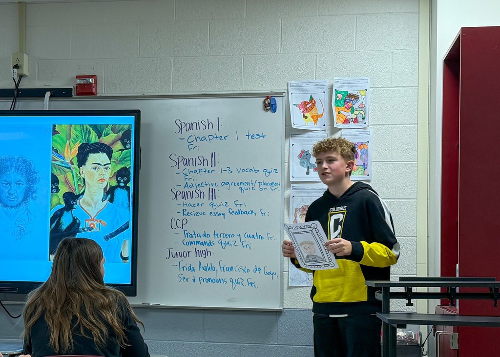 Student presenting the self portrait they created to the class. 