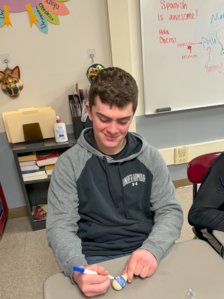 Student decorating maraca.