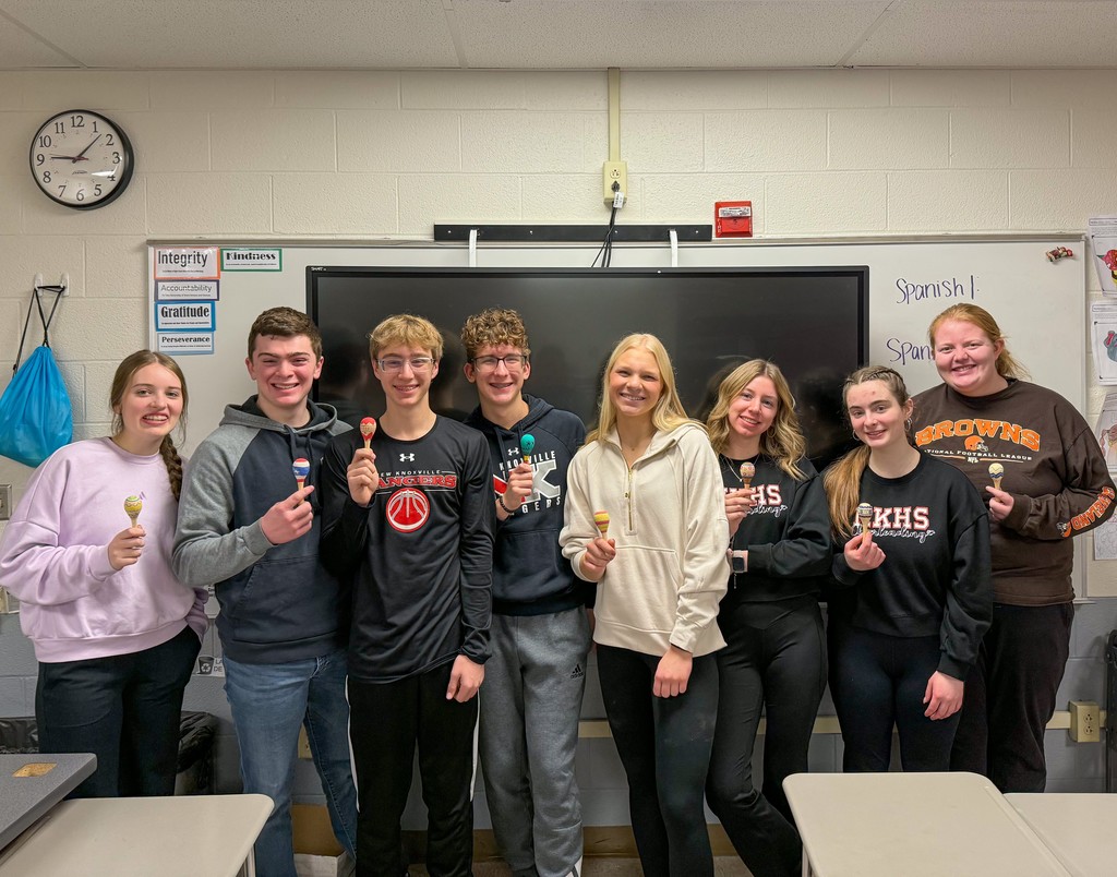 Students holding their completed maracas.