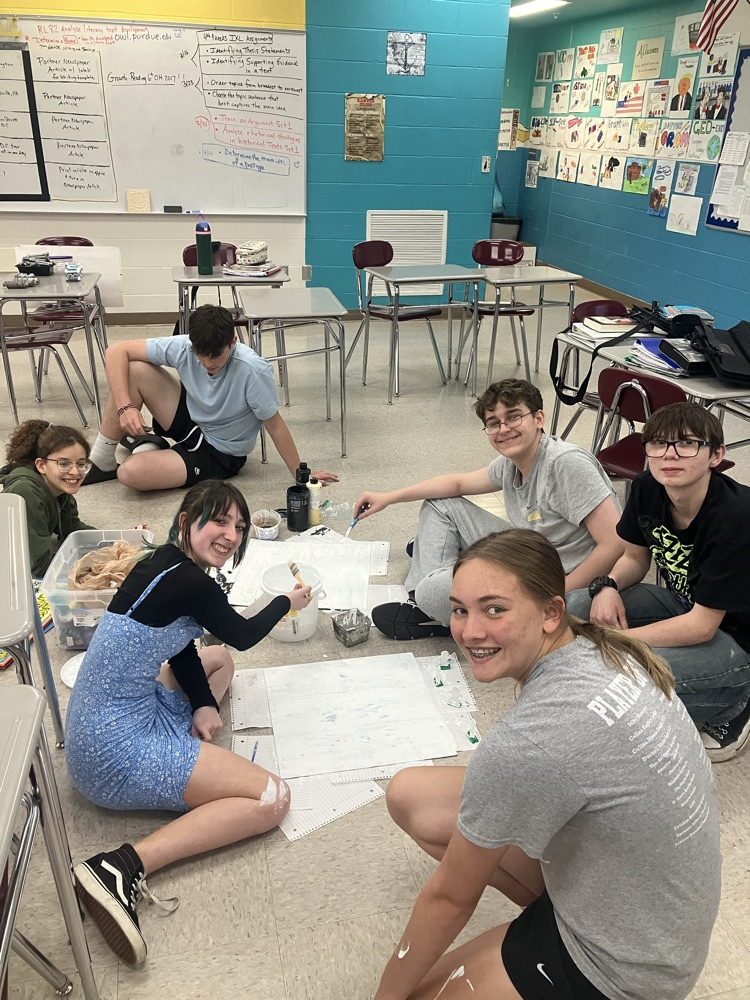 all smiles back in New Knoxville making an educational board game