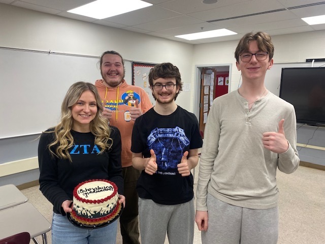 Students with graduation cake