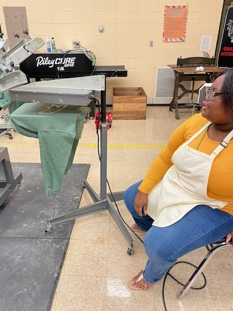 A student drying a shirt.