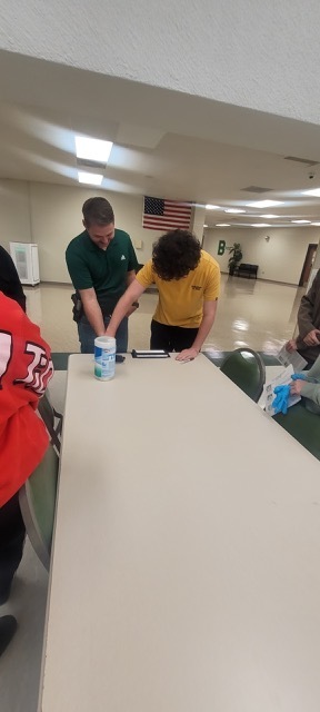 A male student fingerprinting a male adult.