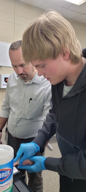 A student fingerprinting an adult