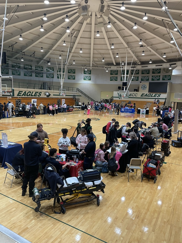 a different view of booths at a career fair with students in attendance