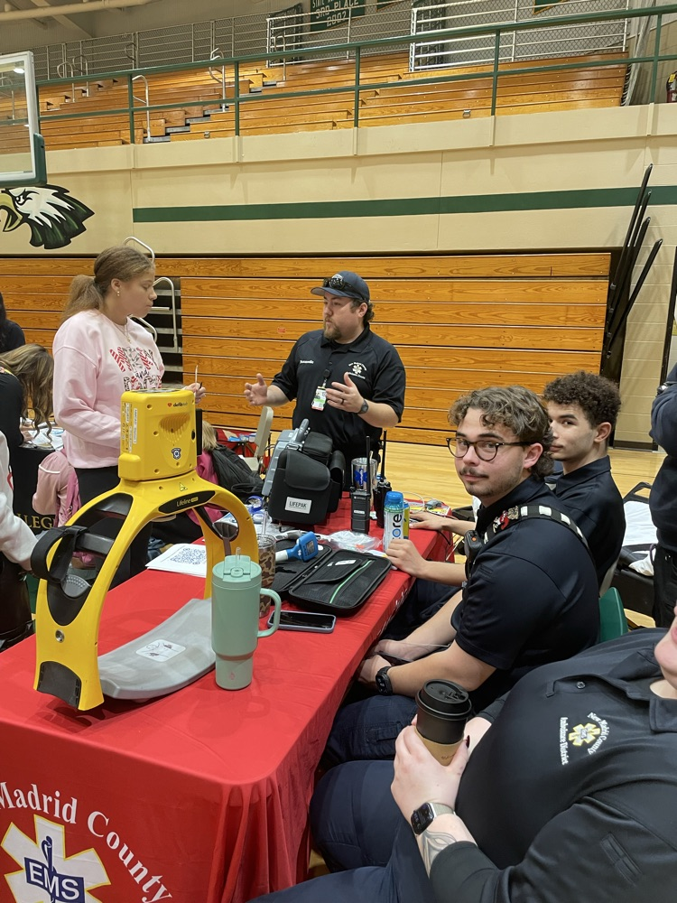 An ambulance booth and students talking to them