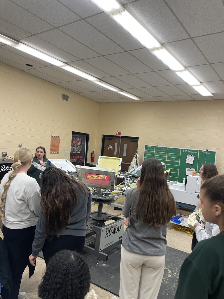 Students learning about the printing shirts.