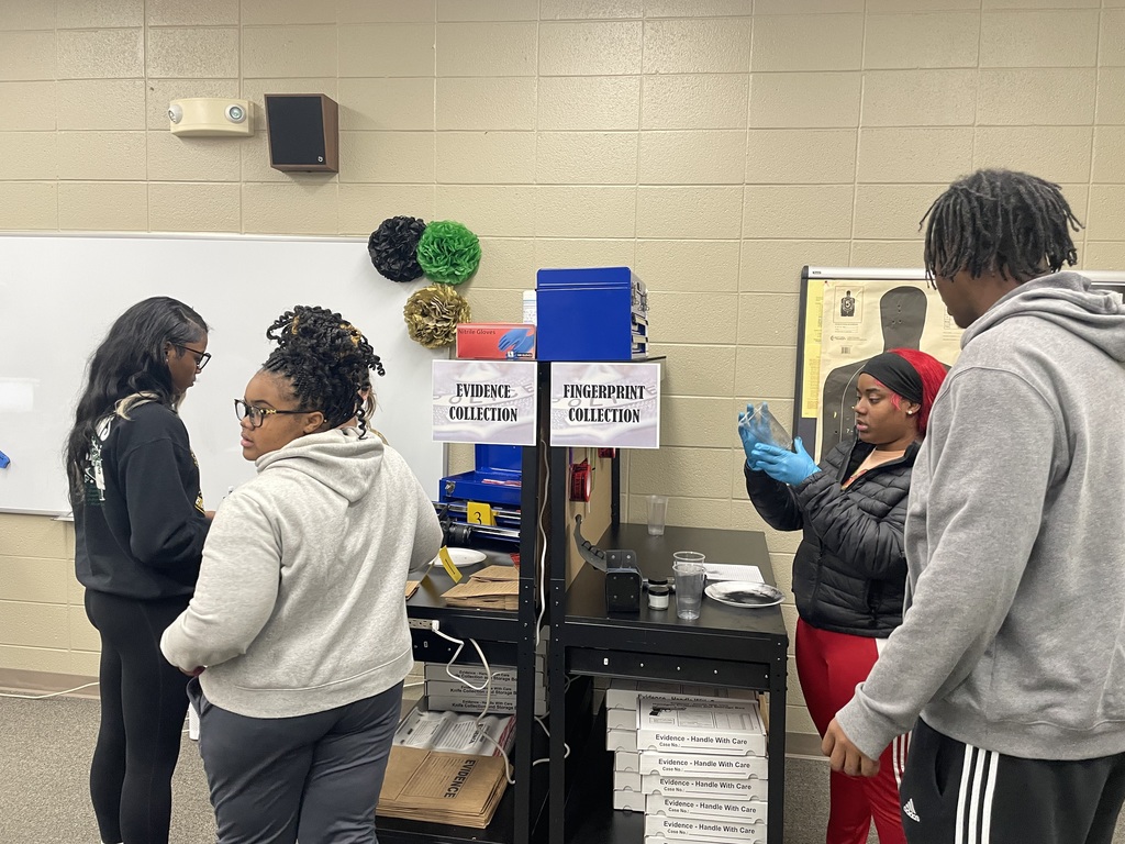 Students at a evidence and fingerprint lab in the Criminal Justice classroom.