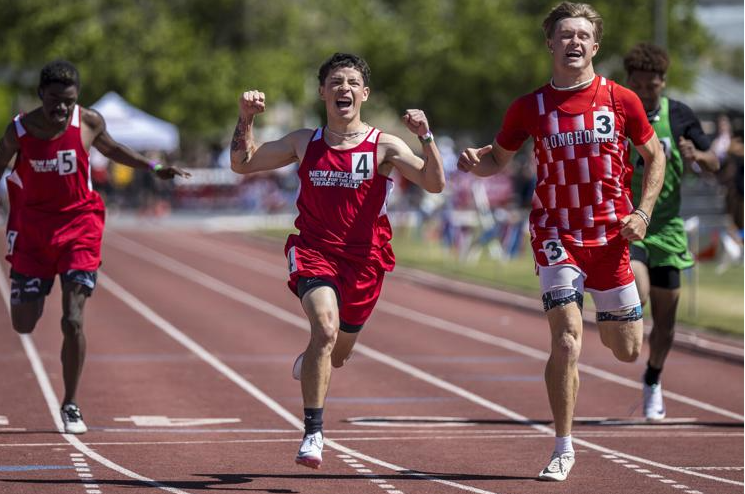 Santiago Lopez crossing the finish line at track meet 