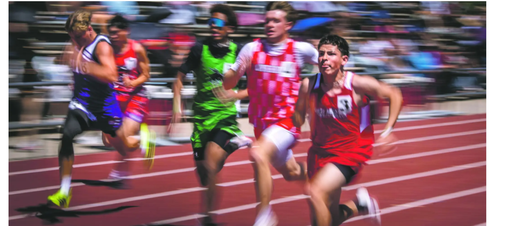 Santiago Lopez crossing the finish line at track meet 
