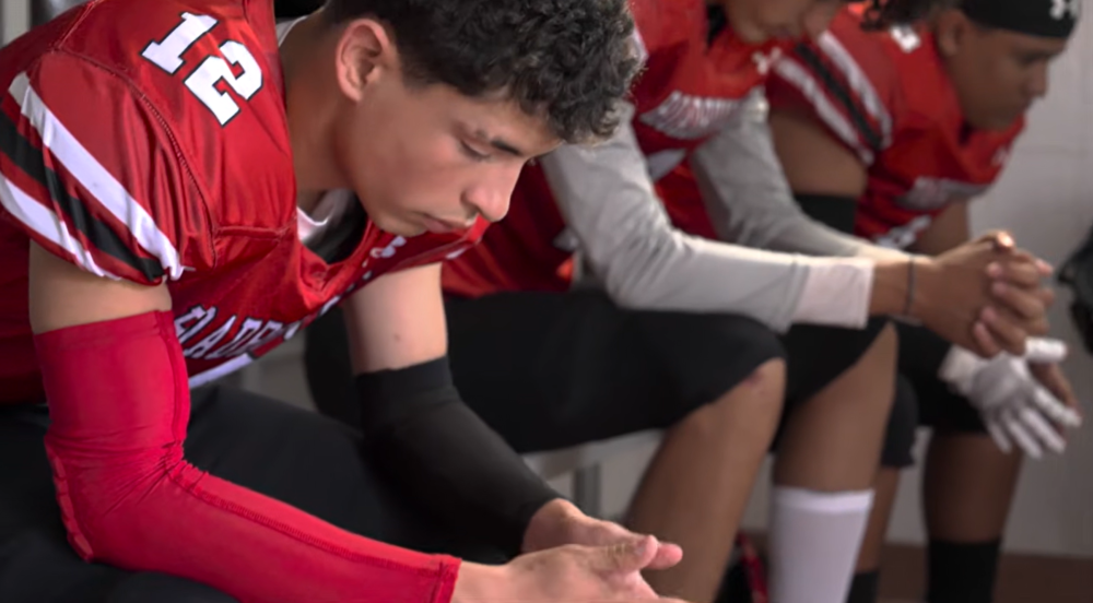 High school senior in football uniform 