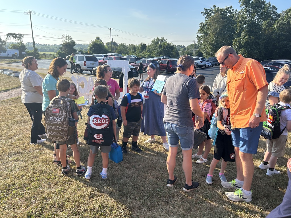 Students meet their teacher outside of Monroe Elementary