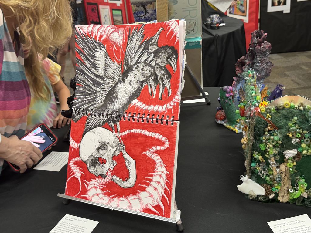 an image of a white skull and three black birds on a red background
