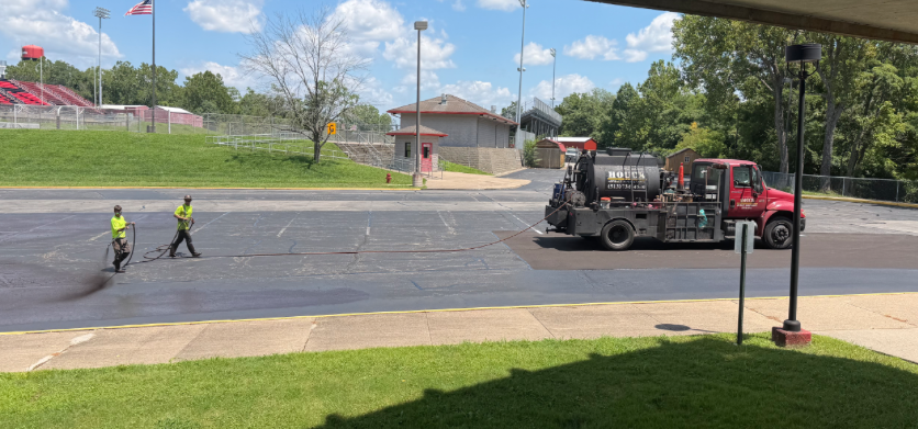 Workers spray the parking lot at NREVSD's Central Office building