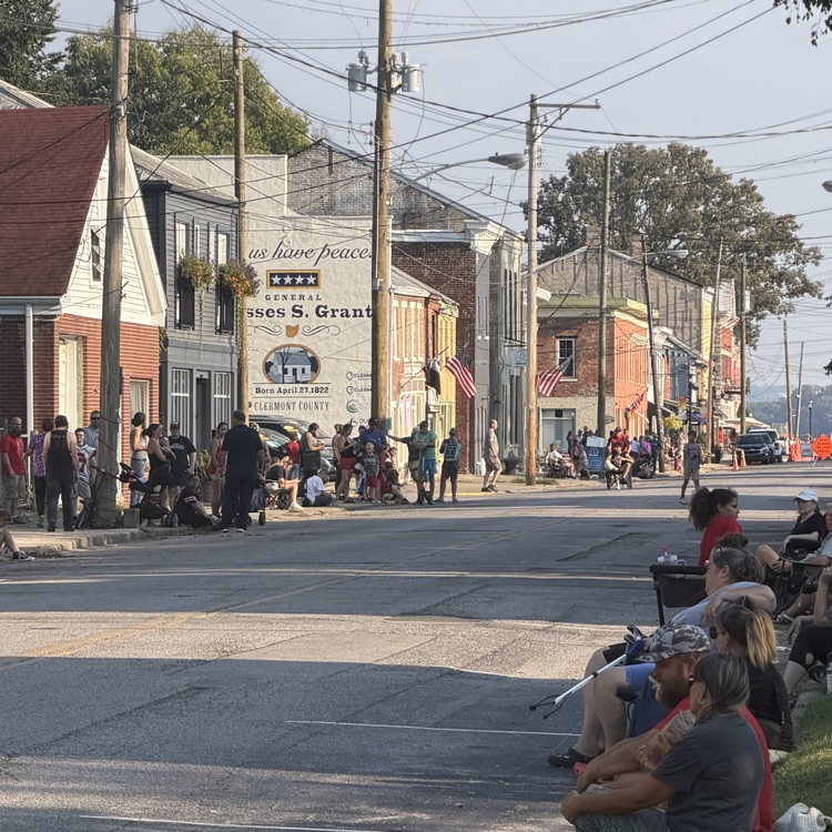 Photo of people lined up along the side of the street in preparation for the 2026 New Richmond homecoming parade.