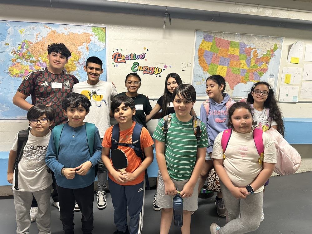 a photo of the ping pong club with their high school mentors