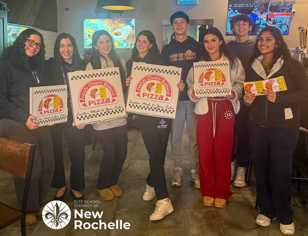 students holding pizza boxes with stickers on them
