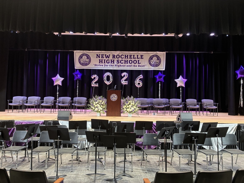 Whitney Auditorium stage decorated for graduation