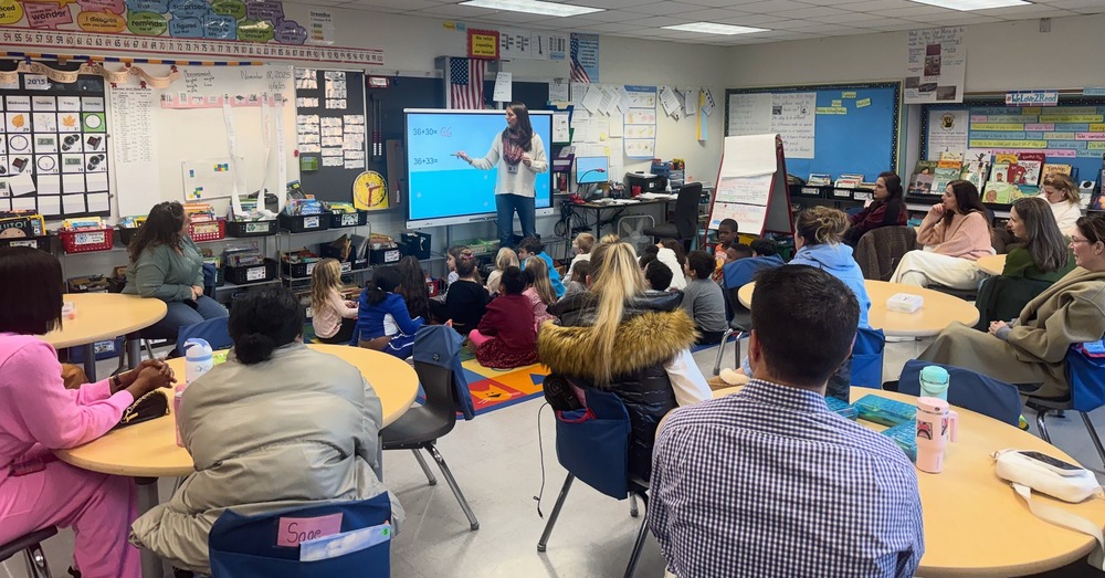Classroom with families listening to a presentation