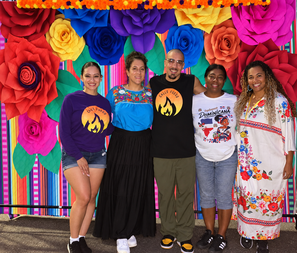Webster's principal with parents in front of a colorful display