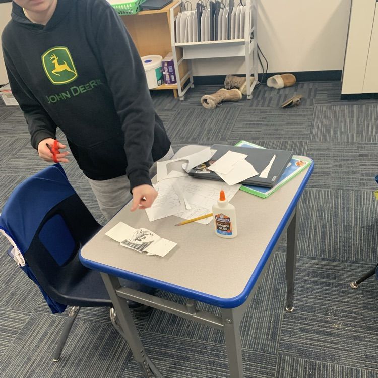 Fifth grade making bookmarks out of old books for reading month!