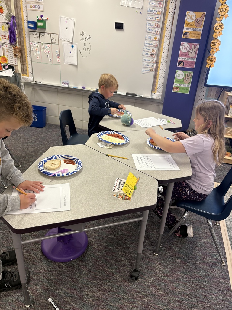 3 students working on their pizza bagels.