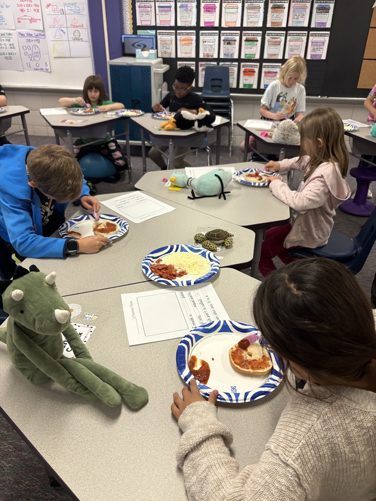 A group of students working on making their pizzas on a bagel.