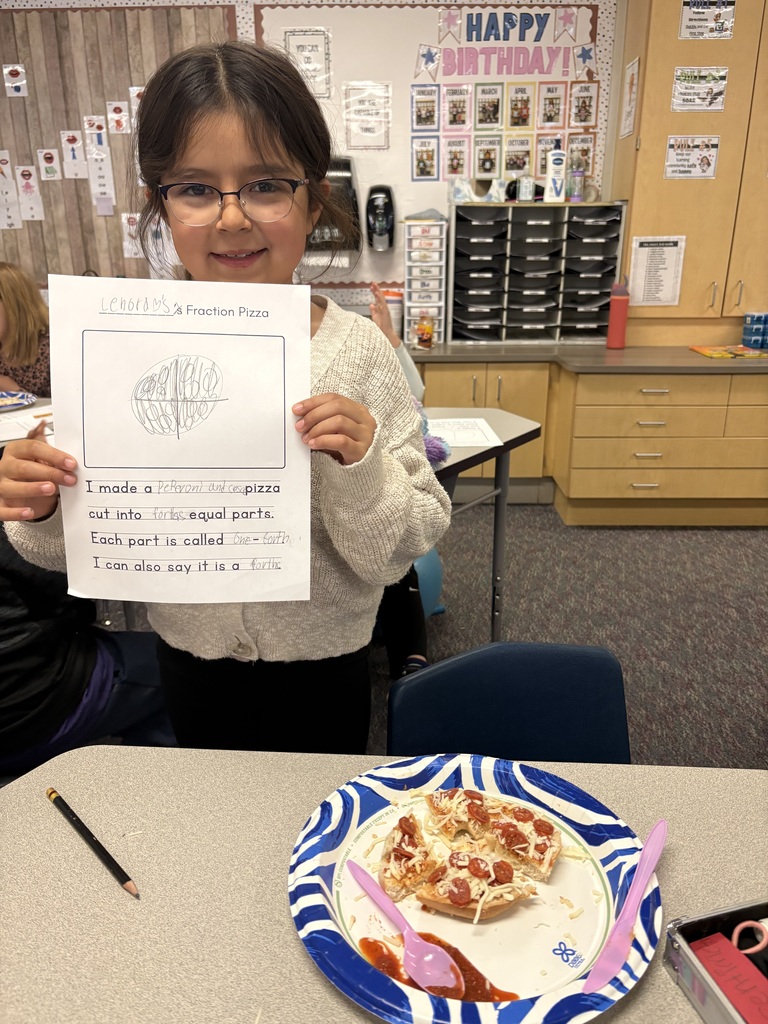 A student with their completed pizza bagel broken up  into a specific fraction as detailed on their worksheet.