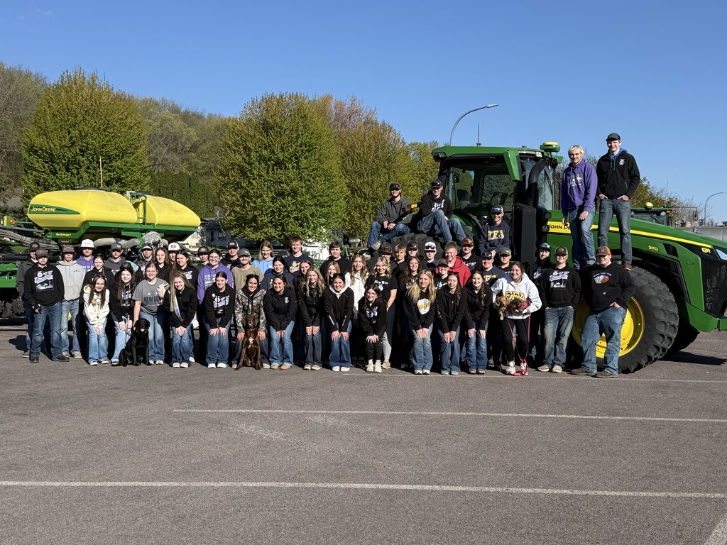 A group photo of all the FFA HS students who were at Ag Day, including some on a tractor in the back.