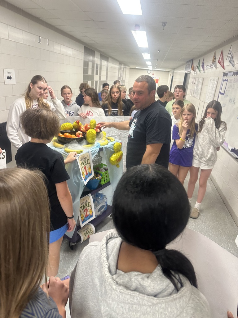 Students with their cart in the gym teacher hallway, delivering to Mr. Olson.