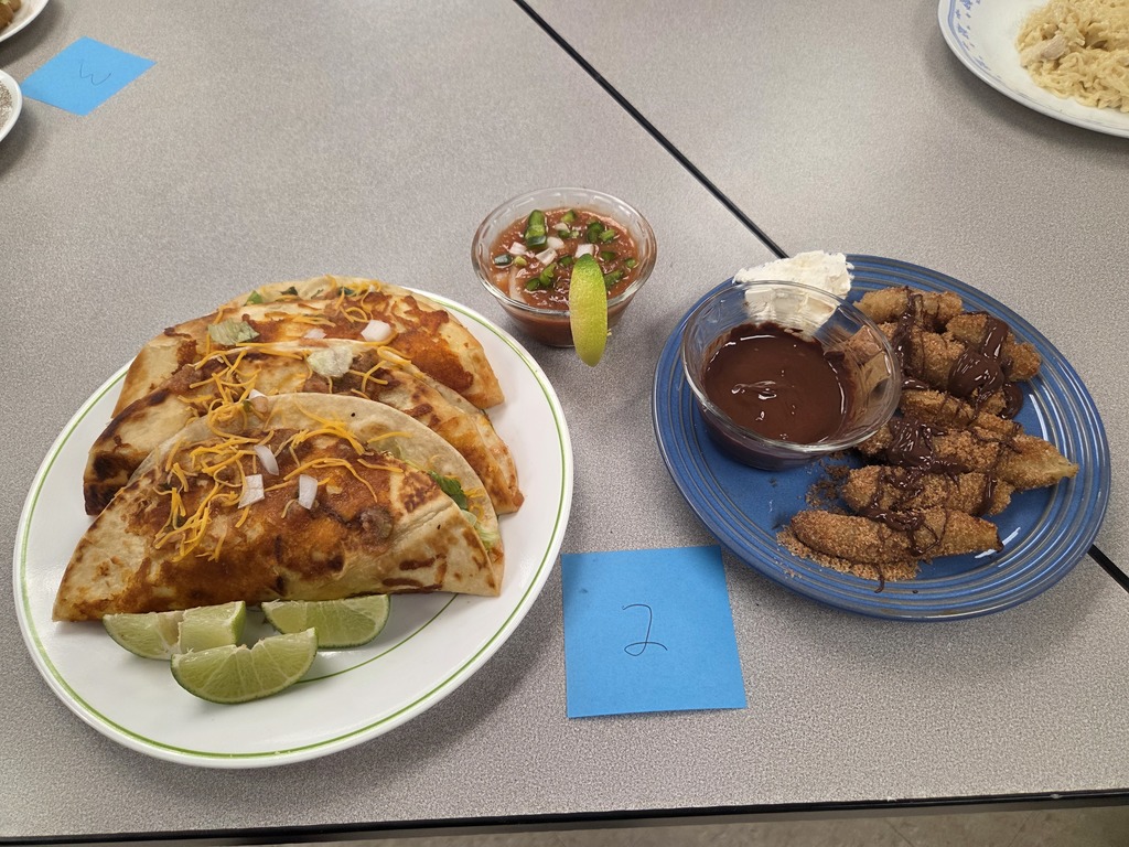 A plate of tacos, a cup of salsa, and a plate of churros with chocolate sauce and whipped topping.