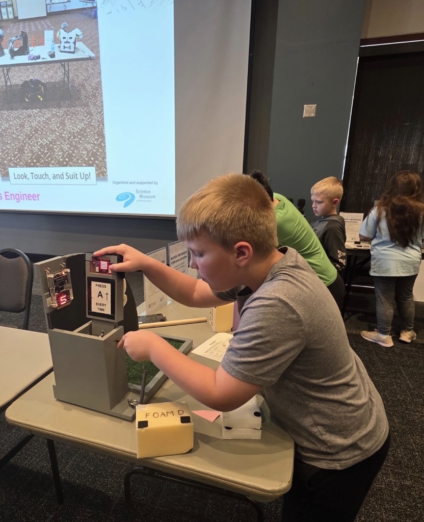 Students at a hands-on engineering exhibit.