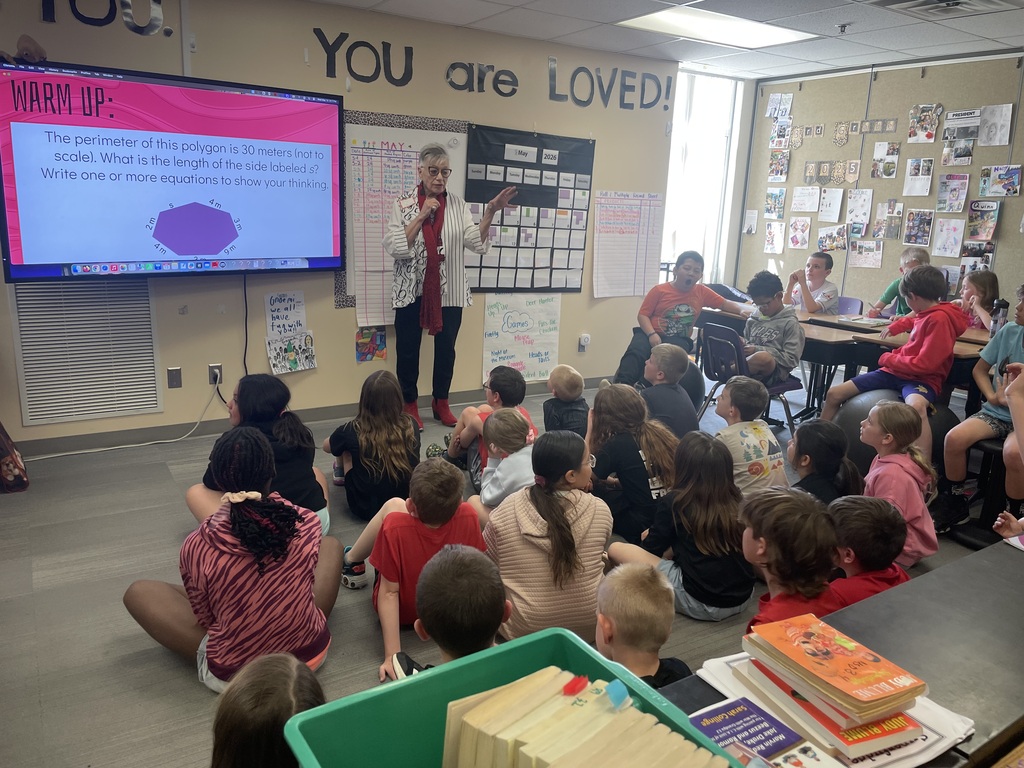 The mayor speaks to the students in a classroom.