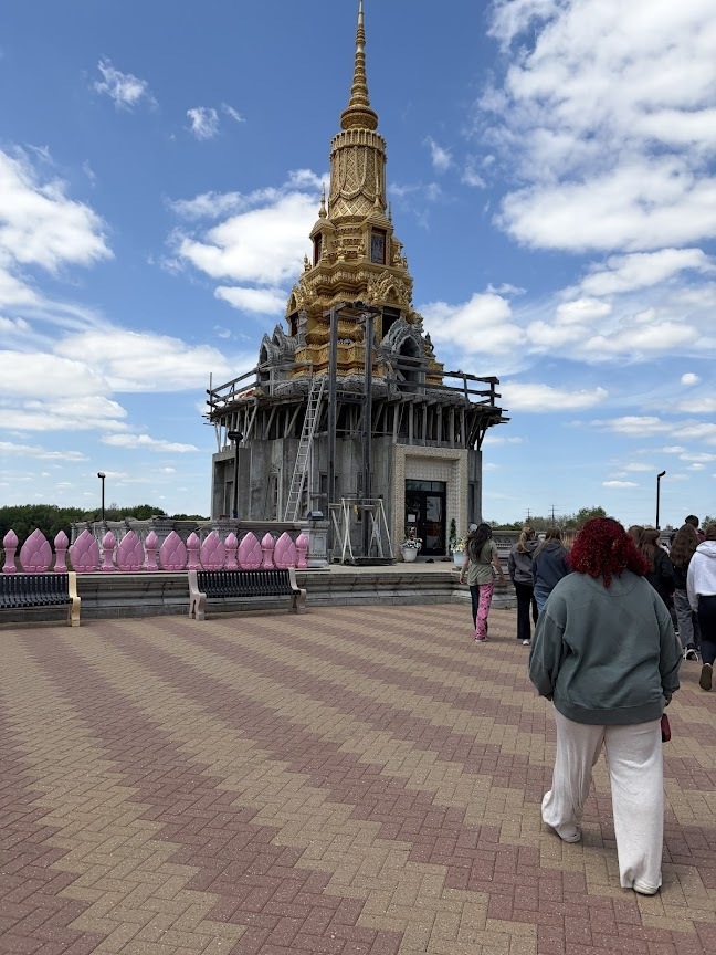 A view outside and perhaps on the temple, with students walking towards it.