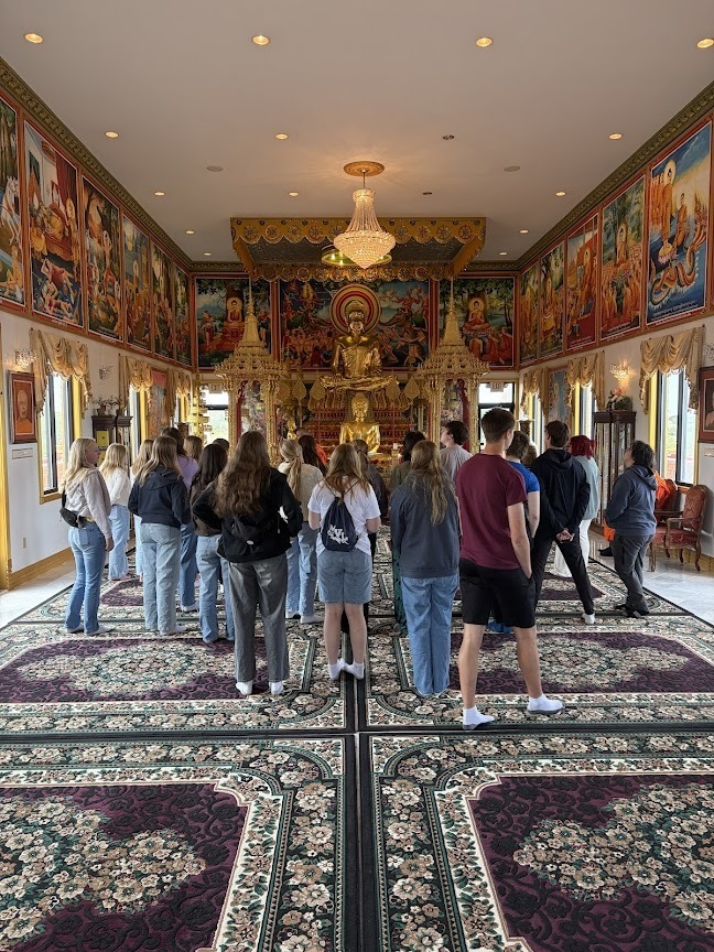 Group of students looking around inside the temple.