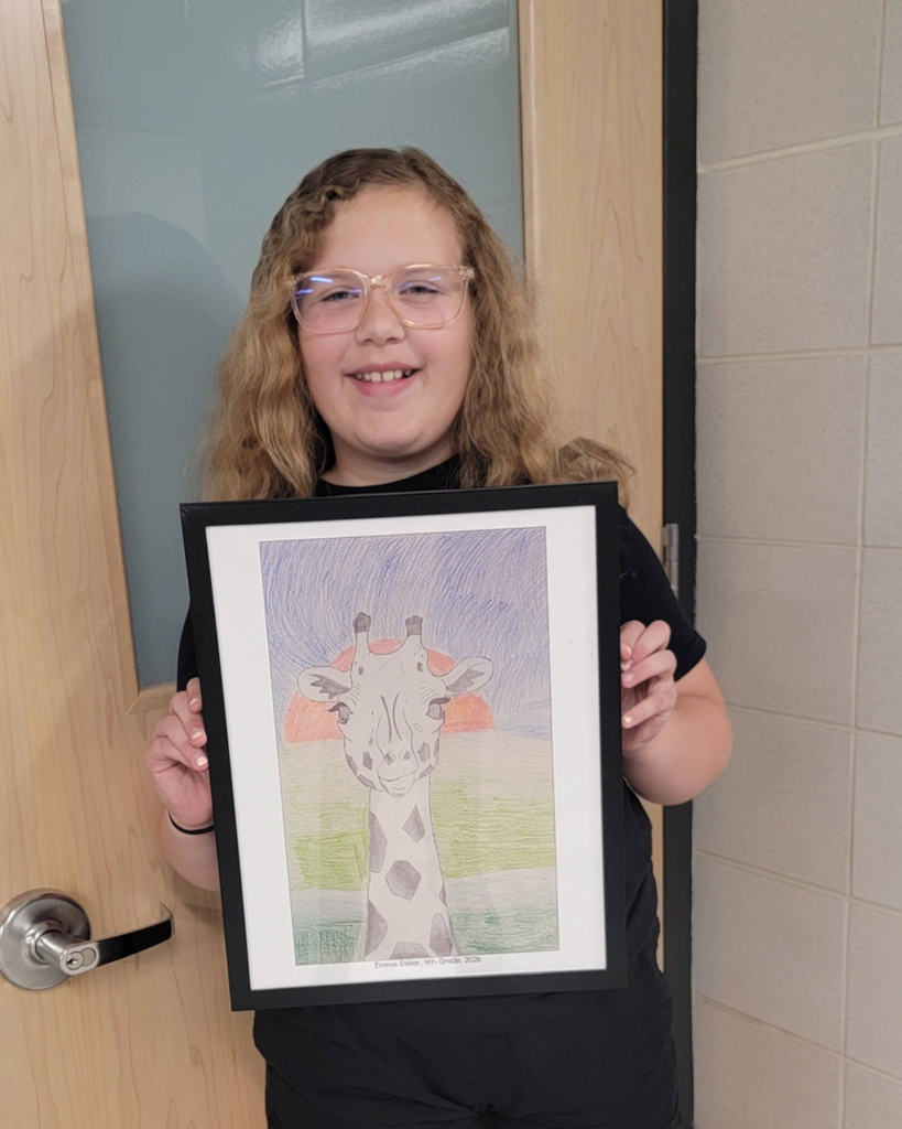 4th grader Emma R. holding her illustration of a giraffe.